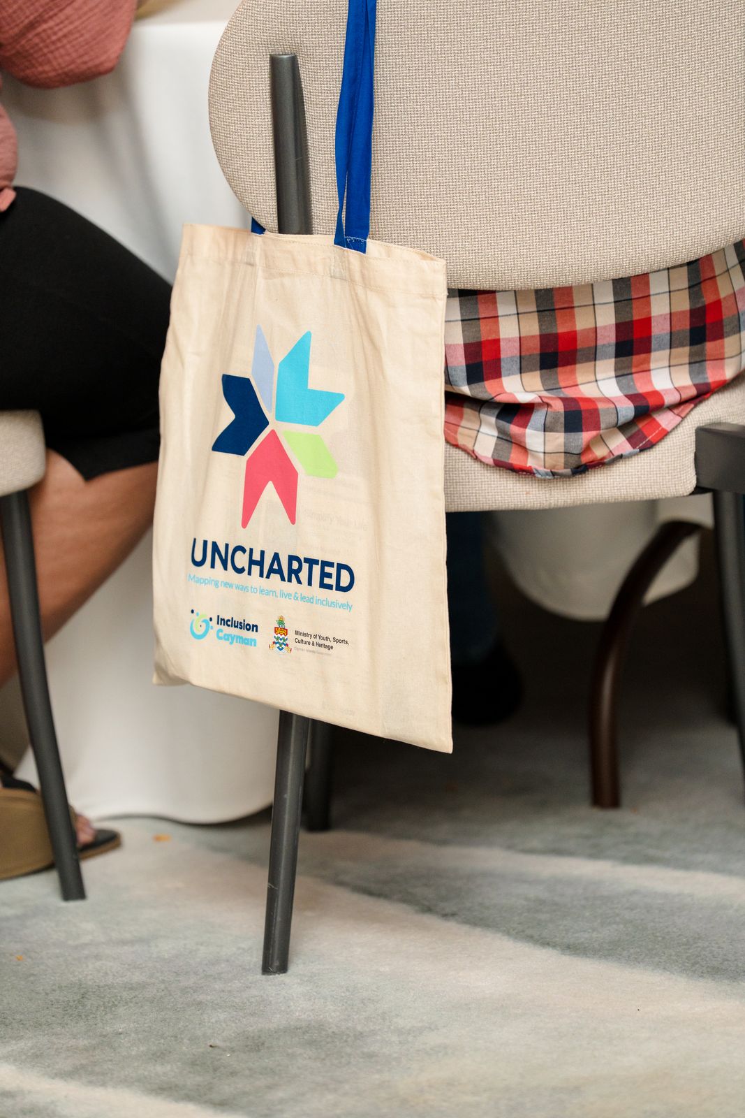 Uncharted Conference bag hanging on back of chair at conference