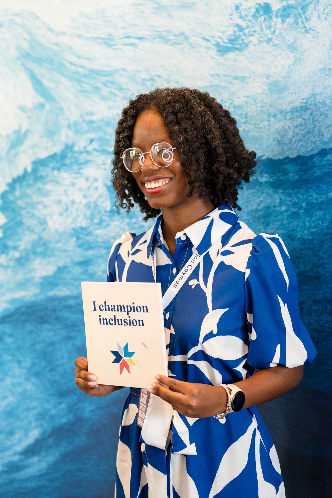 I champion inclusion sign in womans hand smiling 
